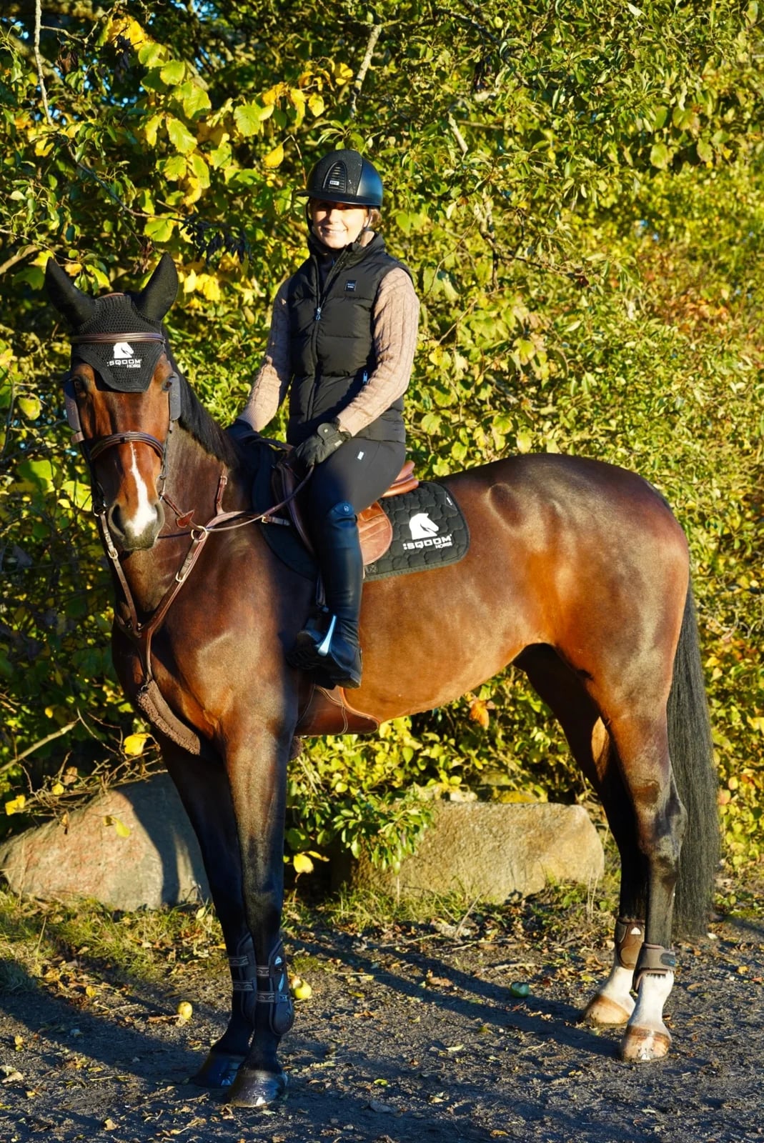 Linda Heed on horseback among the autumn trees
